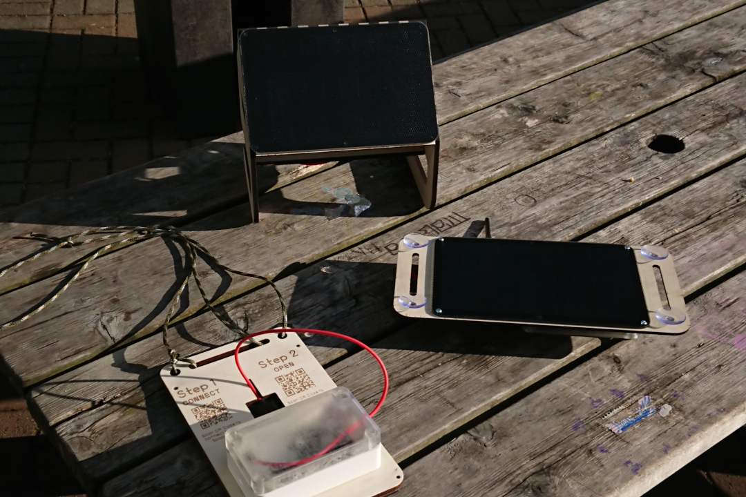 A number of different designs of Solar Space modules are laid out on a bench.