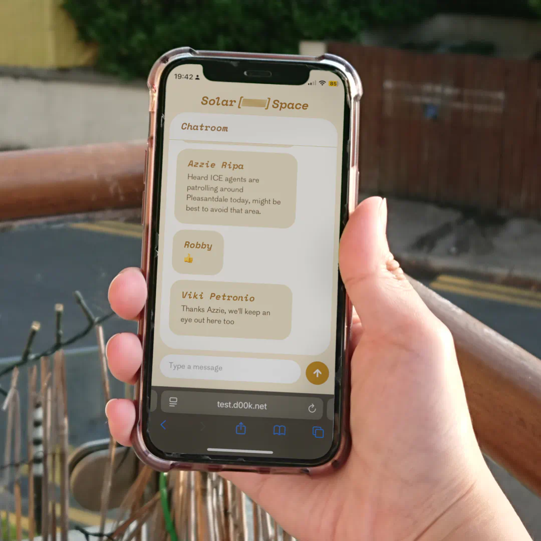 The final app application running on a person's phone. The app is clean and vibrant, we can see a community discussing a local happening.